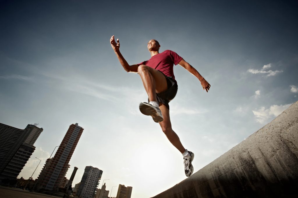 active men running in the city