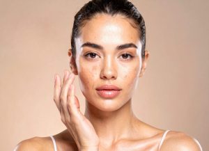 woman brown spot face beauty glowing skin brown background