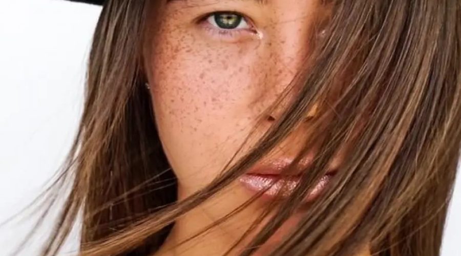 cynatine hair woman face and her brown hair beauty with a hat