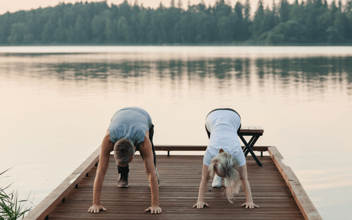 men and women longevity on a lake streching
